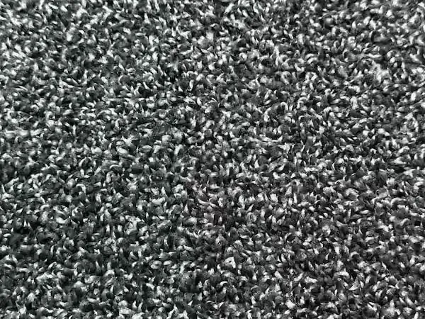 Close-up of charcoal and grey stain-resistant cut-pile carpet installed by Artistry Floors