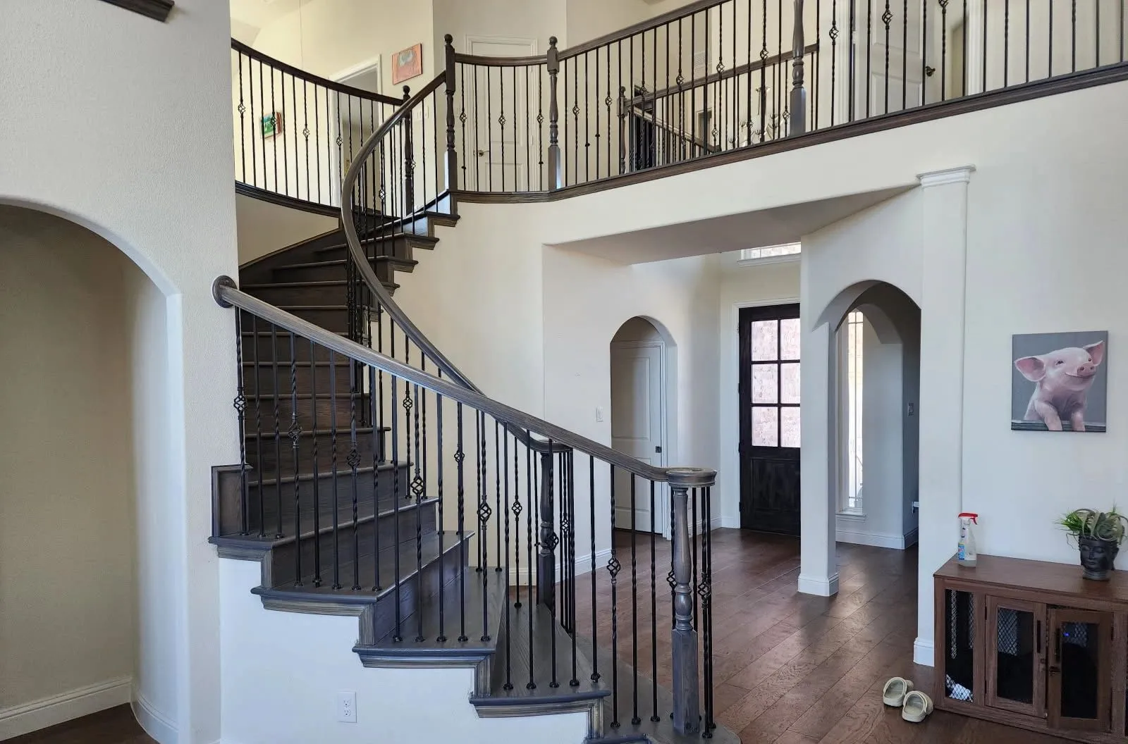 Hardwood flooring and staircase in an Allen, TX entry hall installed by Artistry Floors